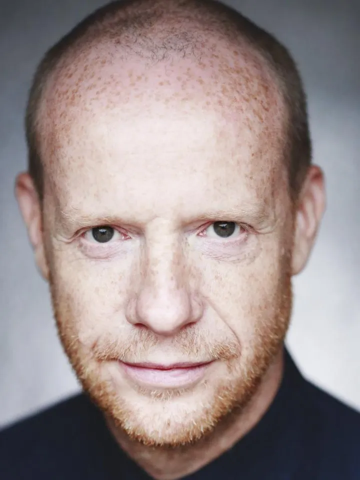 Jonathan Slinger Headshot, a white man with lots of freckles, brown eyes and a short gingery beard.