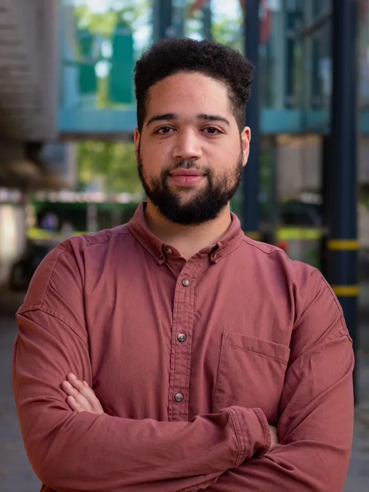 Photo of Simeon Miller With Arms Crossed Looking At Camera